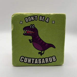 Funny slogan 'Don't Be a Cuntasaurus' printed on square travertine stone coaster