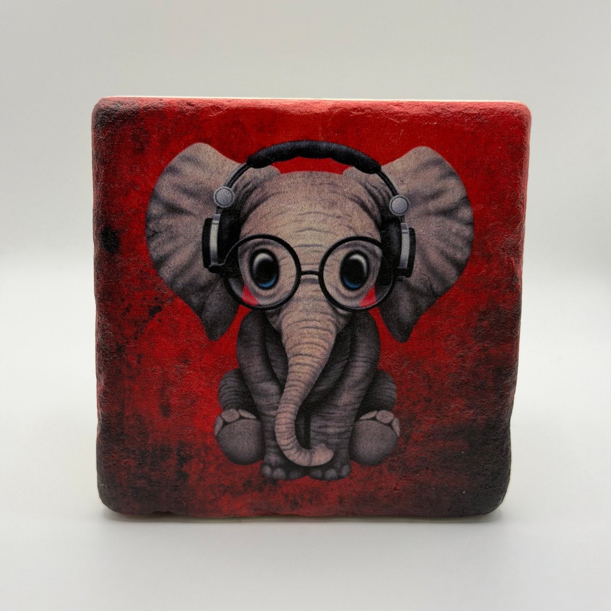 Illustration of an elephant printed on square travertine stone coaster