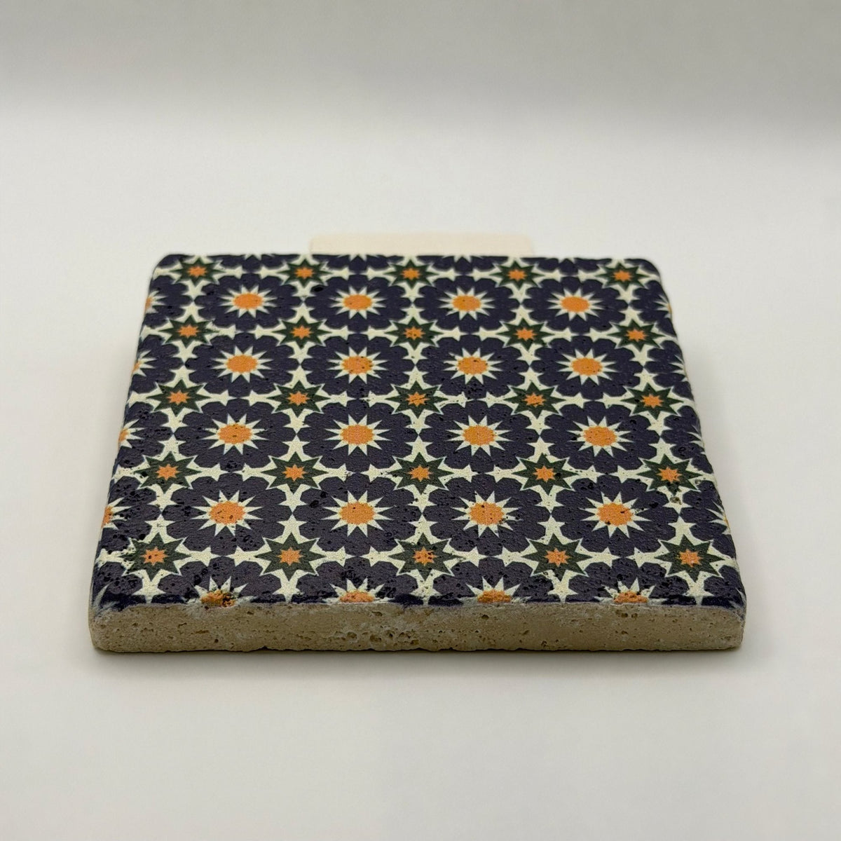 Ethnics pattern number 12 printed on a natural travertine stone coaster