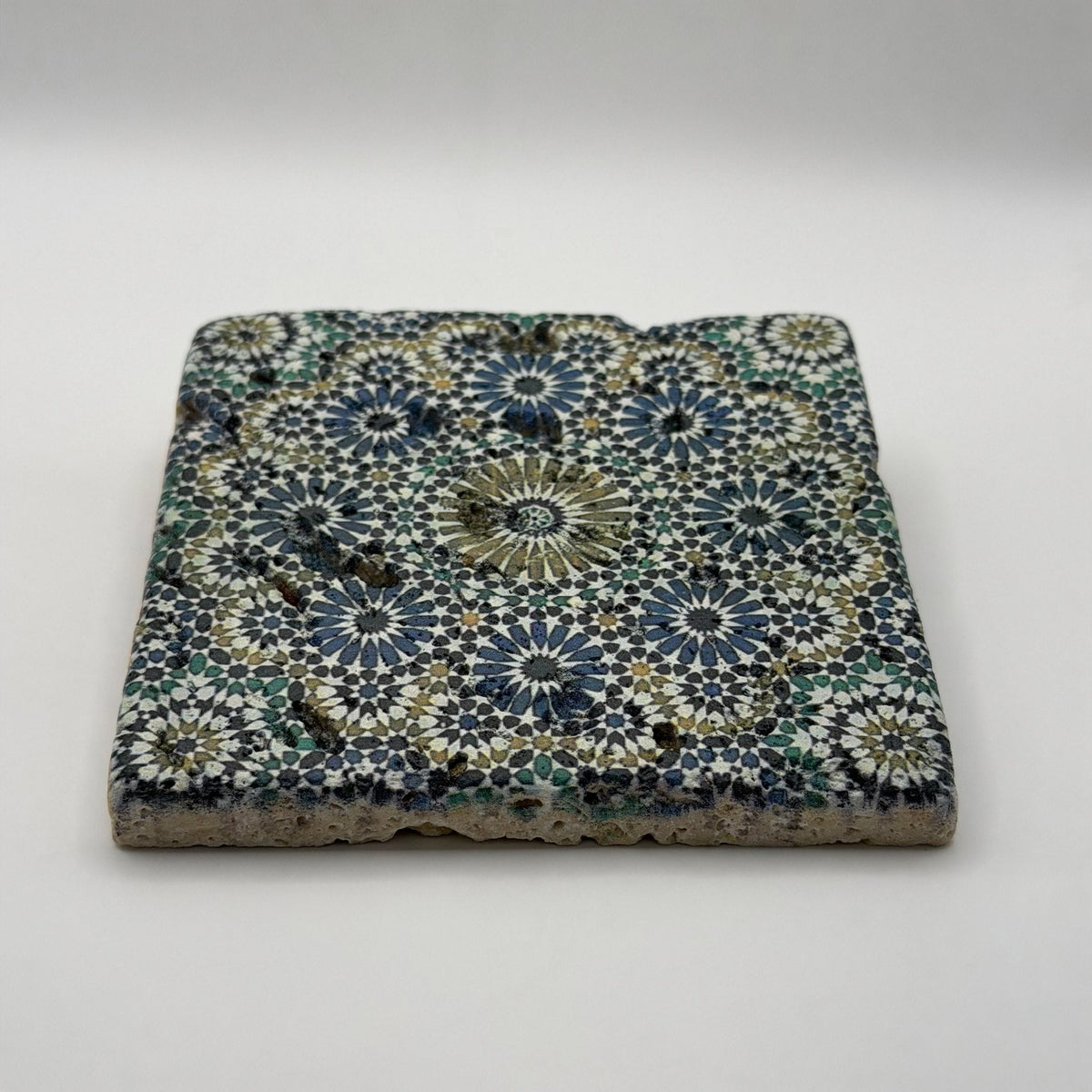 Ethnics pattern number 33 printed on a natural travertine stone coaster