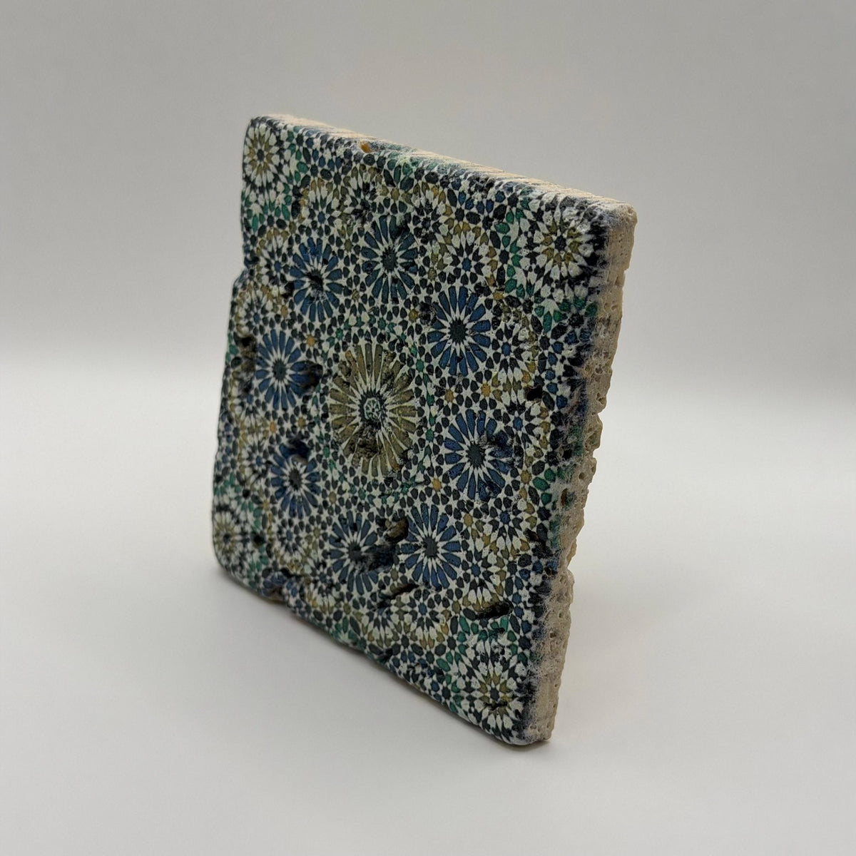Ethnics pattern number 33 printed on a natural travertine stone coaster
