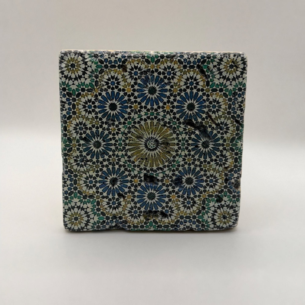 Ethnics pattern number 33 printed on a natural travertine stone coaster