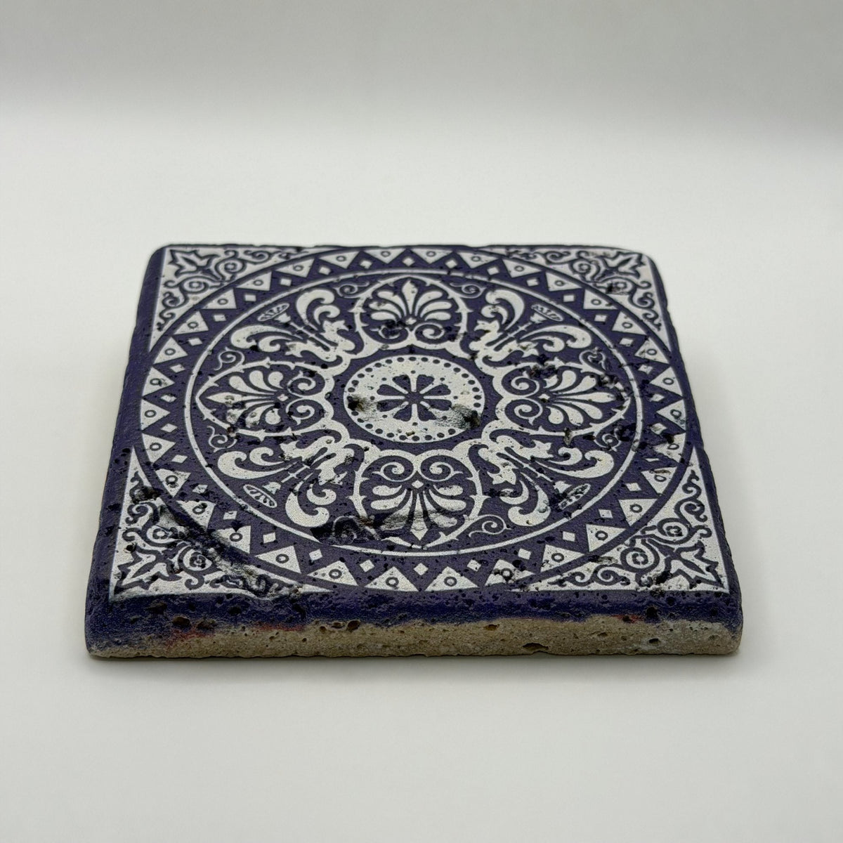 Ethnics pattern number 34 printed on a natural travertine stone coaster