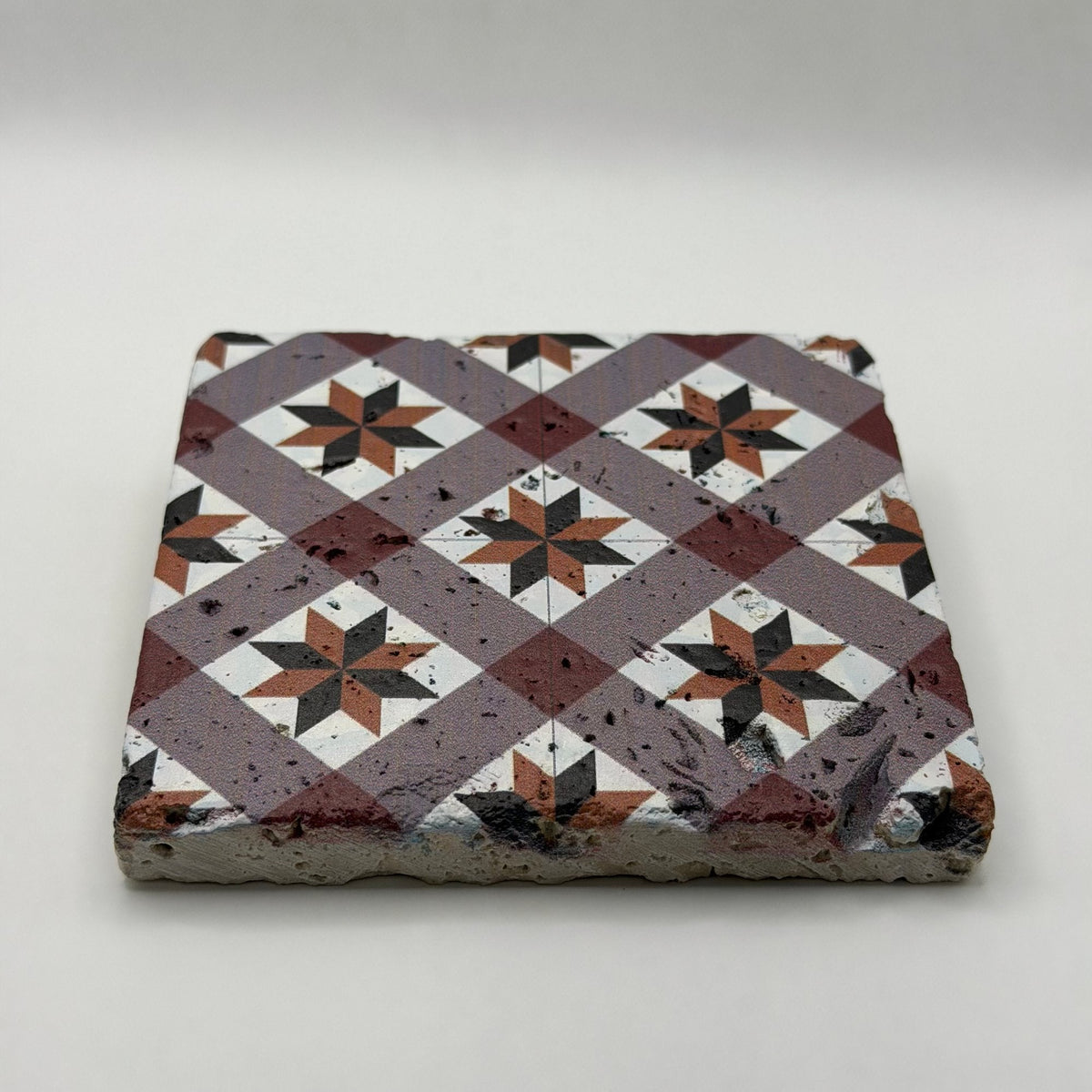 Ethnics pattern number 49 printed on a natural travertine stone coaster