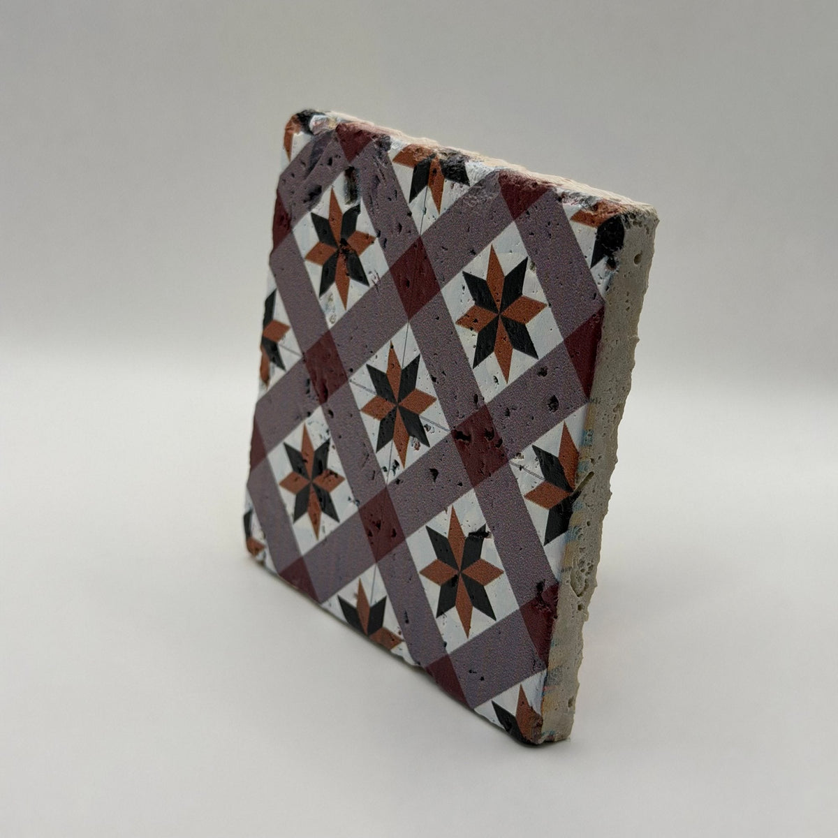 Ethnics pattern number 49 printed on a natural travertine stone coaster