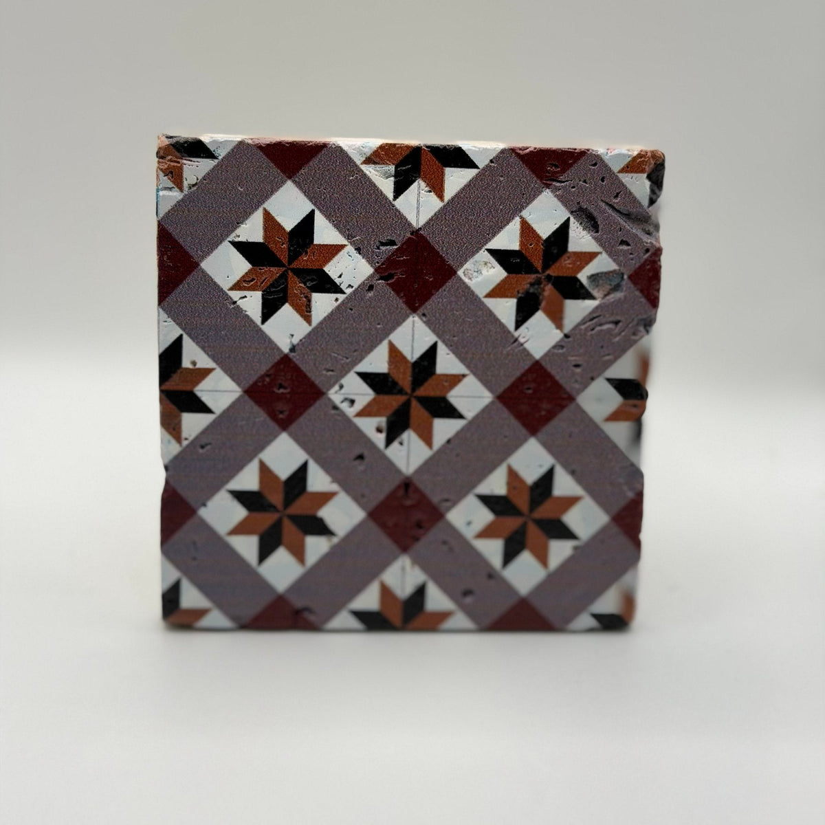 Ethnics pattern number 49 printed on a natural travertine stone coaster