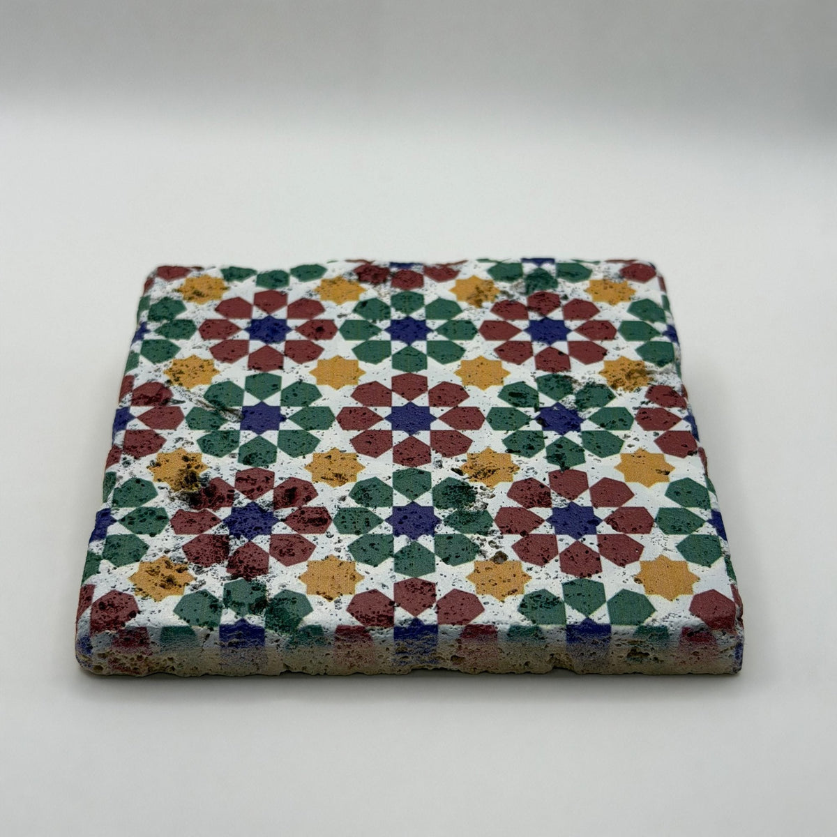 Ethnics pattern number 52 printed on a natural travertine stone coaster