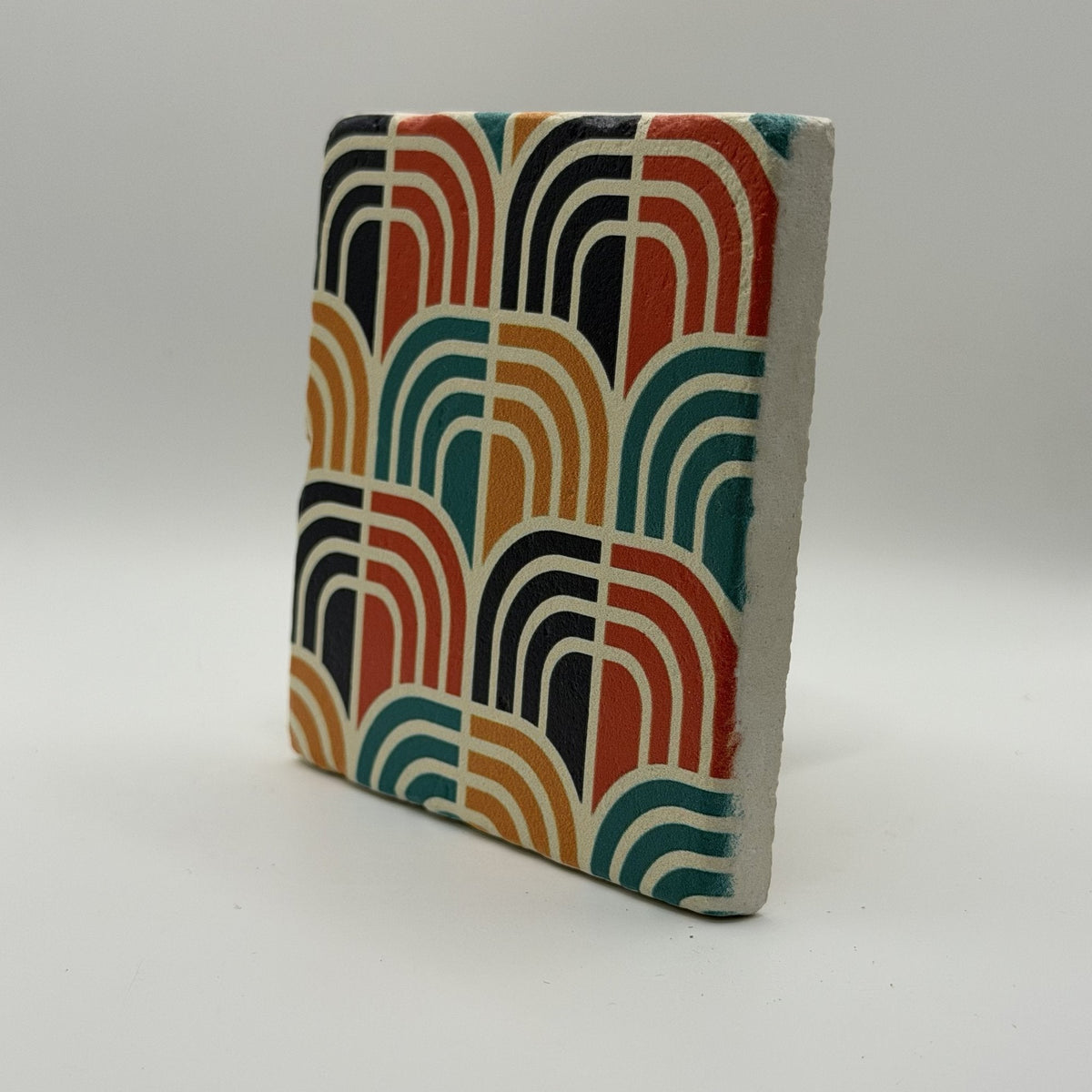 Ethnics pattern number 62 printed on a natural travertine stone coaster