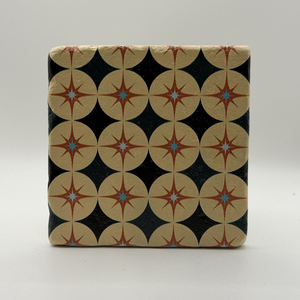 Ethnics pattern number 63 printed on a natural travertine stone coaster