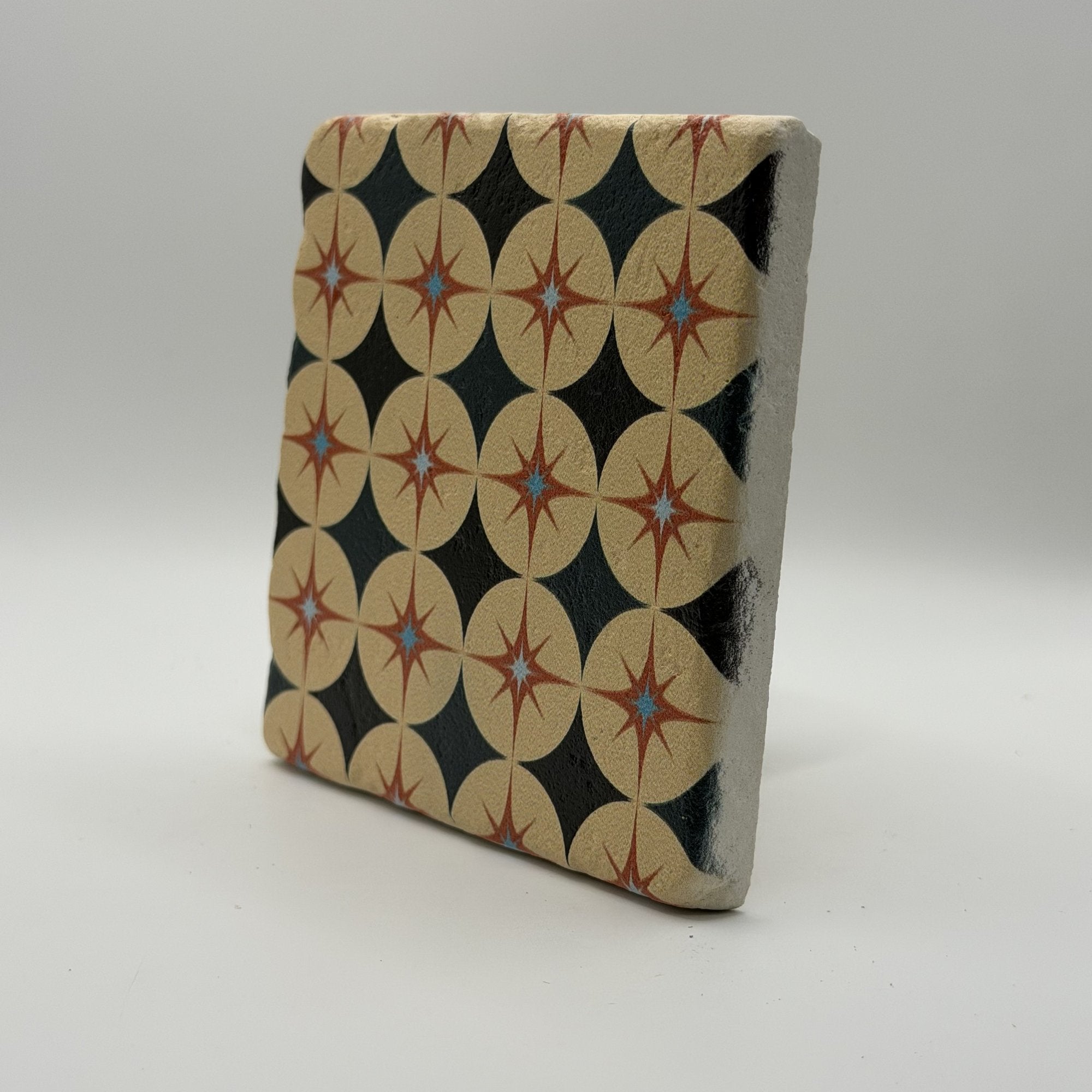 Ethnics pattern number 63 printed on a natural travertine stone coaster