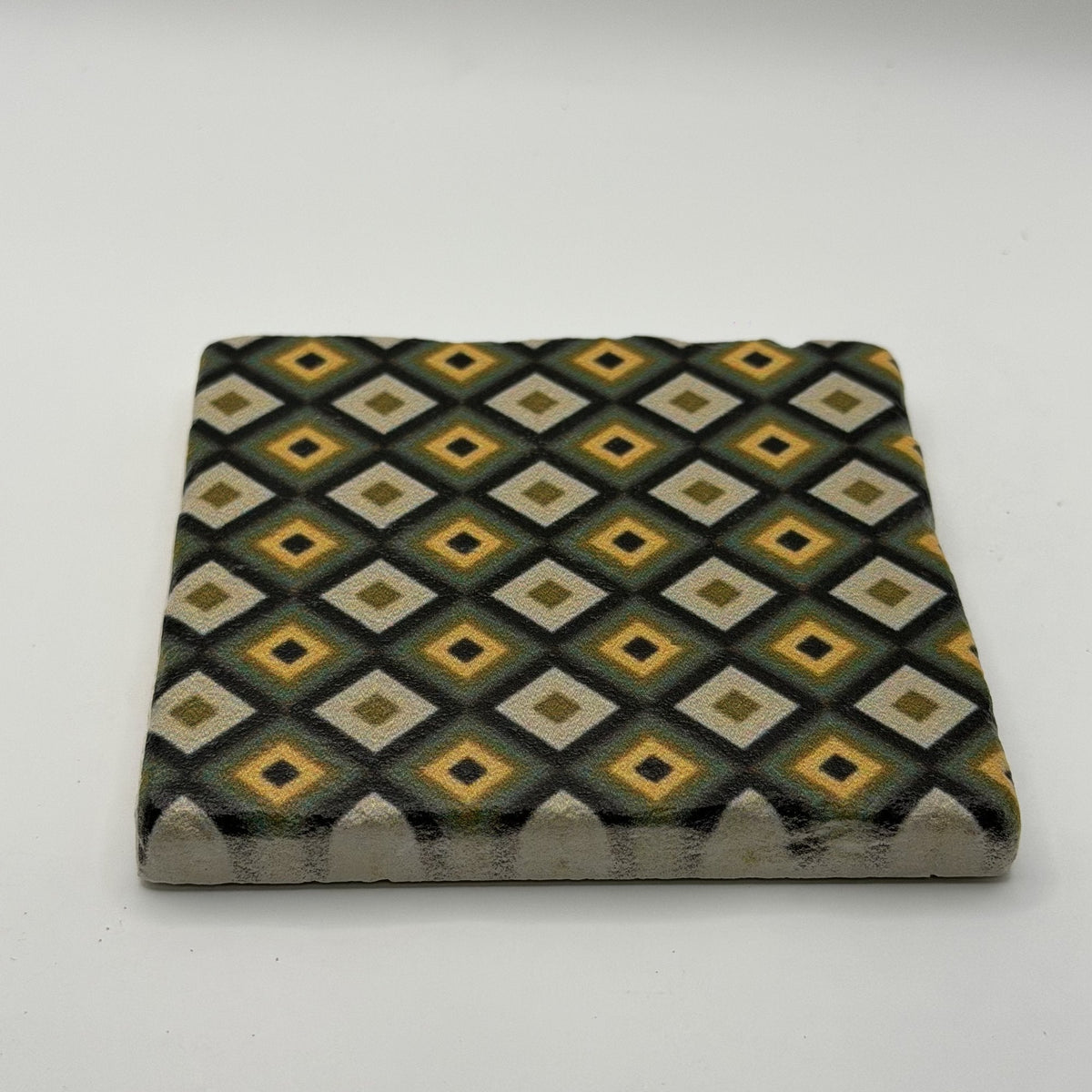 Ethnics pattern number 64 printed on a natural travertine stone coaster