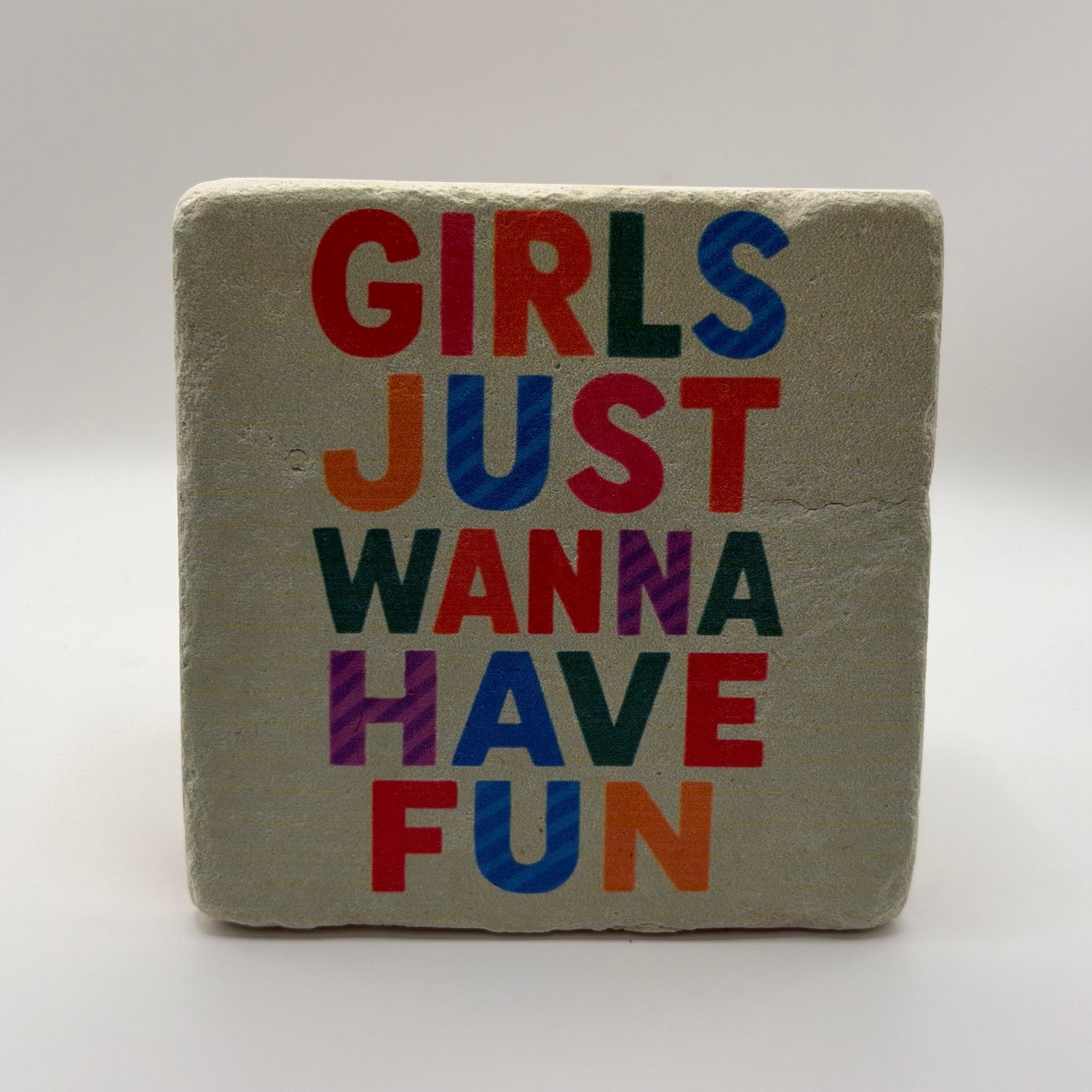 Funny quote 'Girls Just Wanna Have Fun' printed on square travertine stone coaster