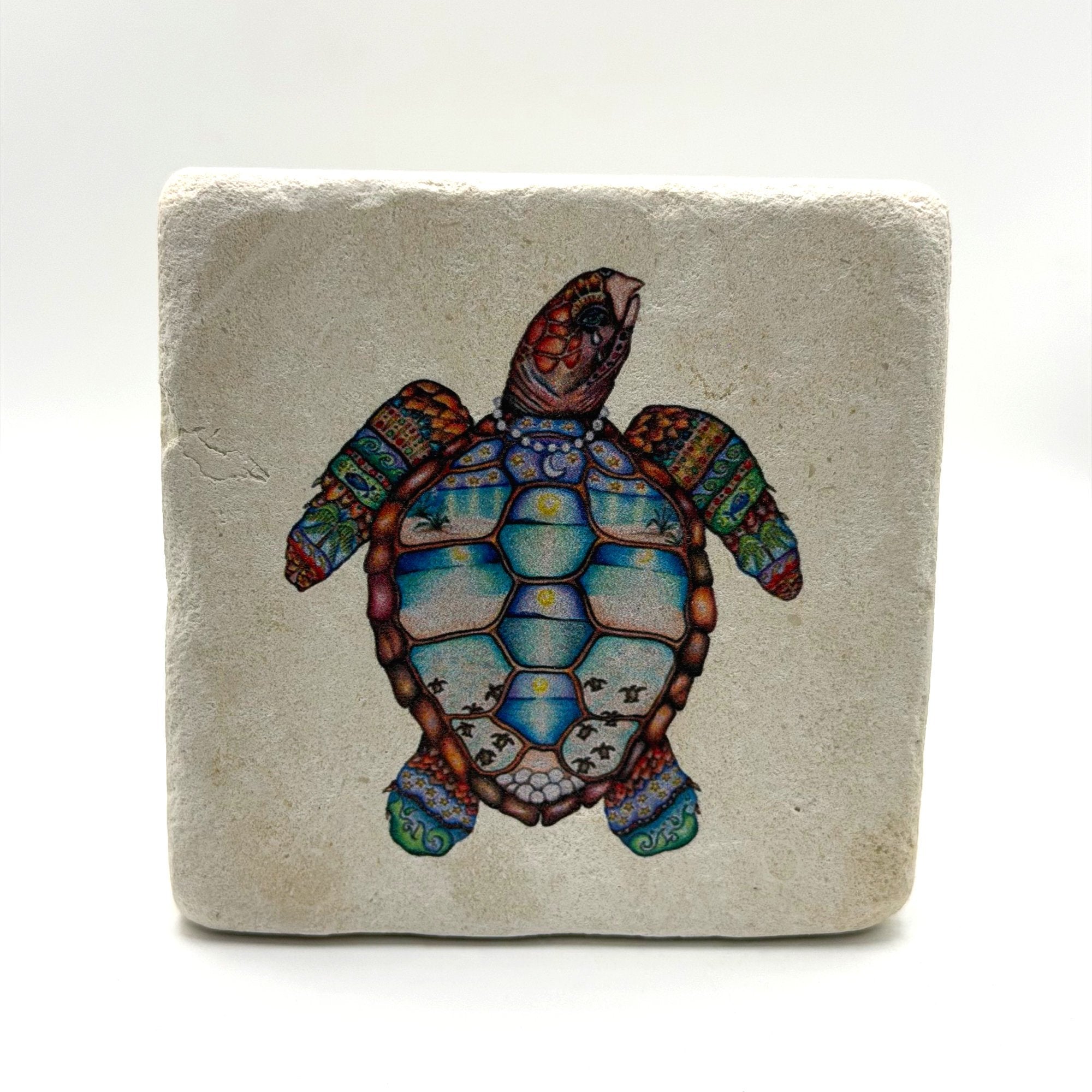 A cute green turtle print on a square travertine stone coaster