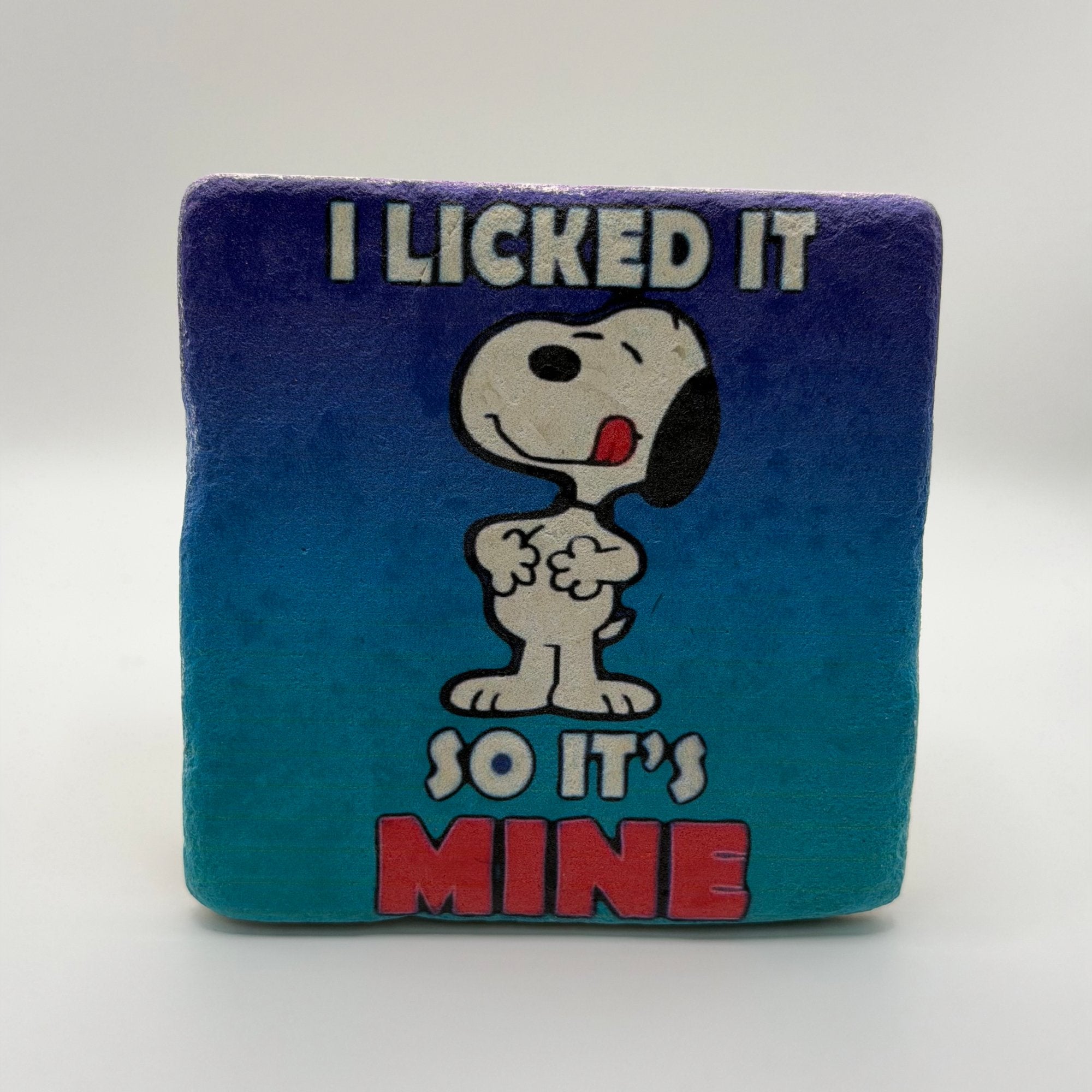 Funny slogan 'I Licked It So It's Mine' printed on square natural travertine stone coaster