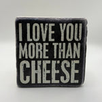 Funny quote 'I Love You More Than Cheese' printed on square travertine stone coaster