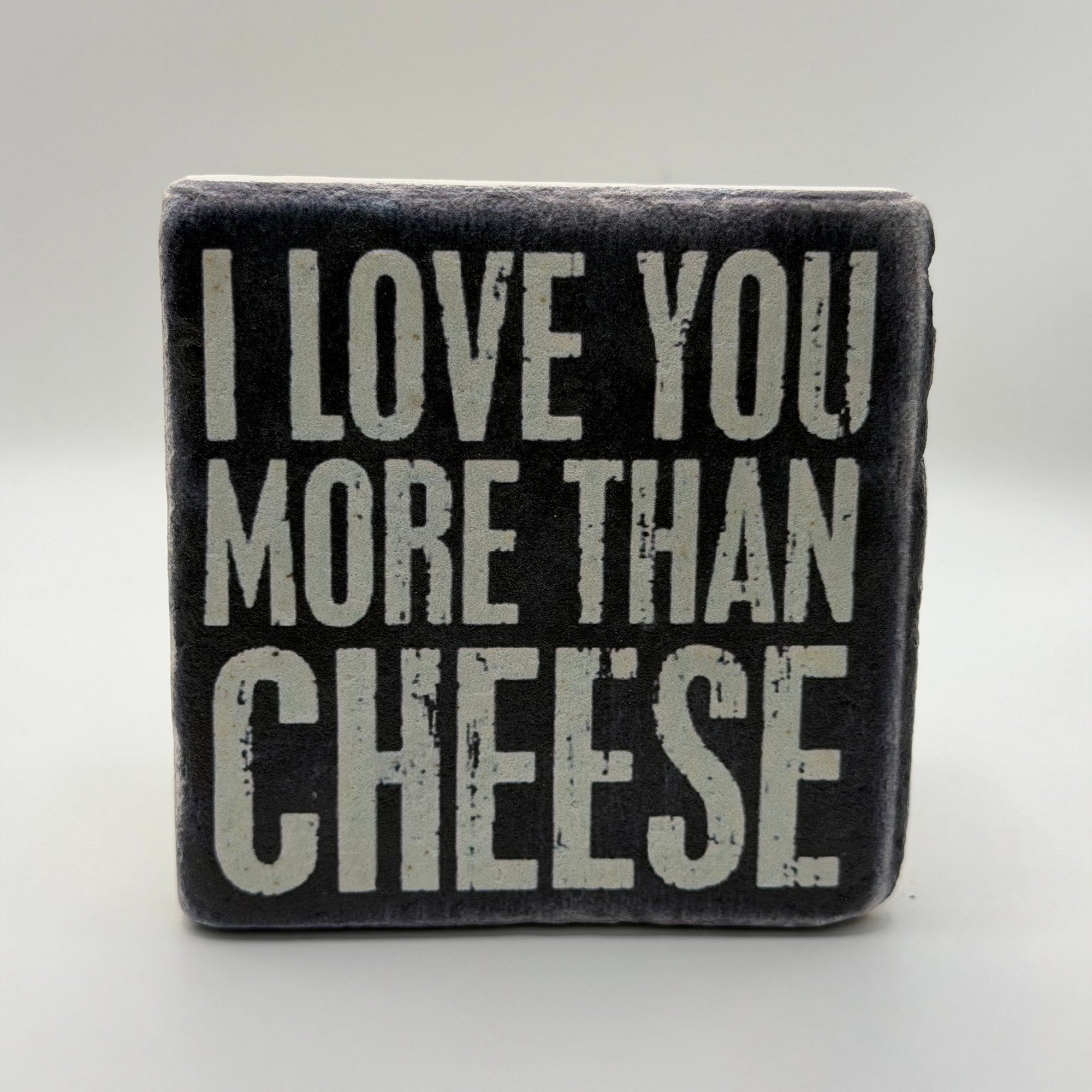 Funny quote 'I Love You More Than Cheese' printed on square travertine stone coaster