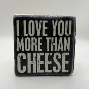 Funny quote 'I Love You More Than Cheese' printed on square travertine stone coaster