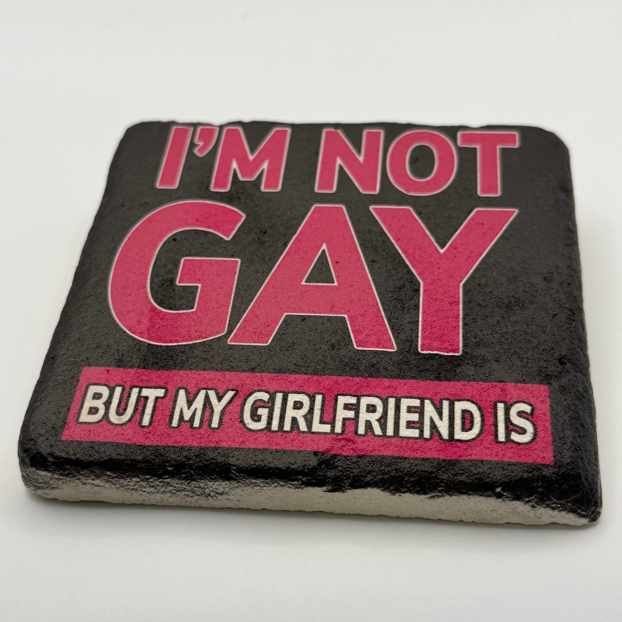 Funny quote 'I'm not gay, but my girlfriend is' printed on square travertine stone coaster