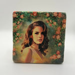 Lana Del Rey artwork featuring rose wreath design printed on square travertine stone coaster