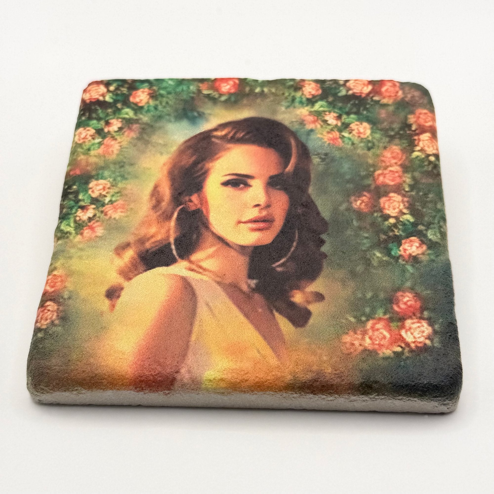 Lana Del Rey artwork featuring rose wreath design printed on square travertine stone coaster