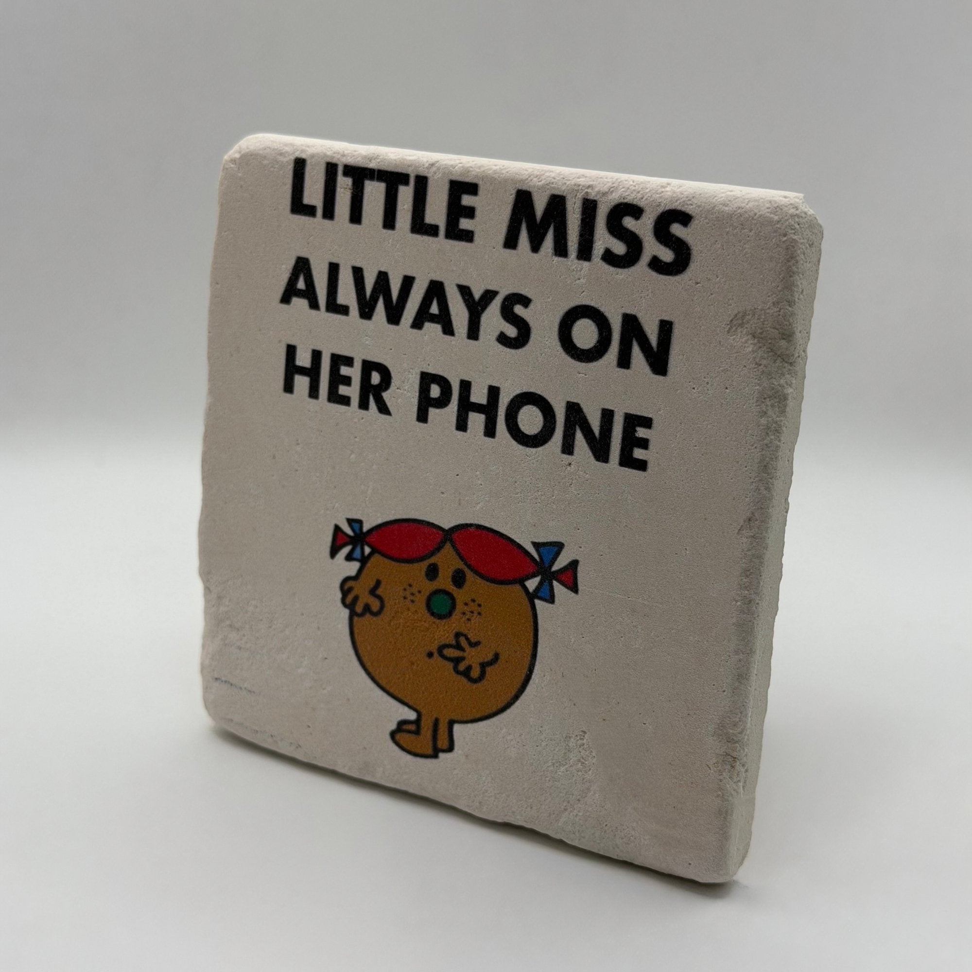 Little Miss Always On Her Phone artwork printed on square travertine stone coaster