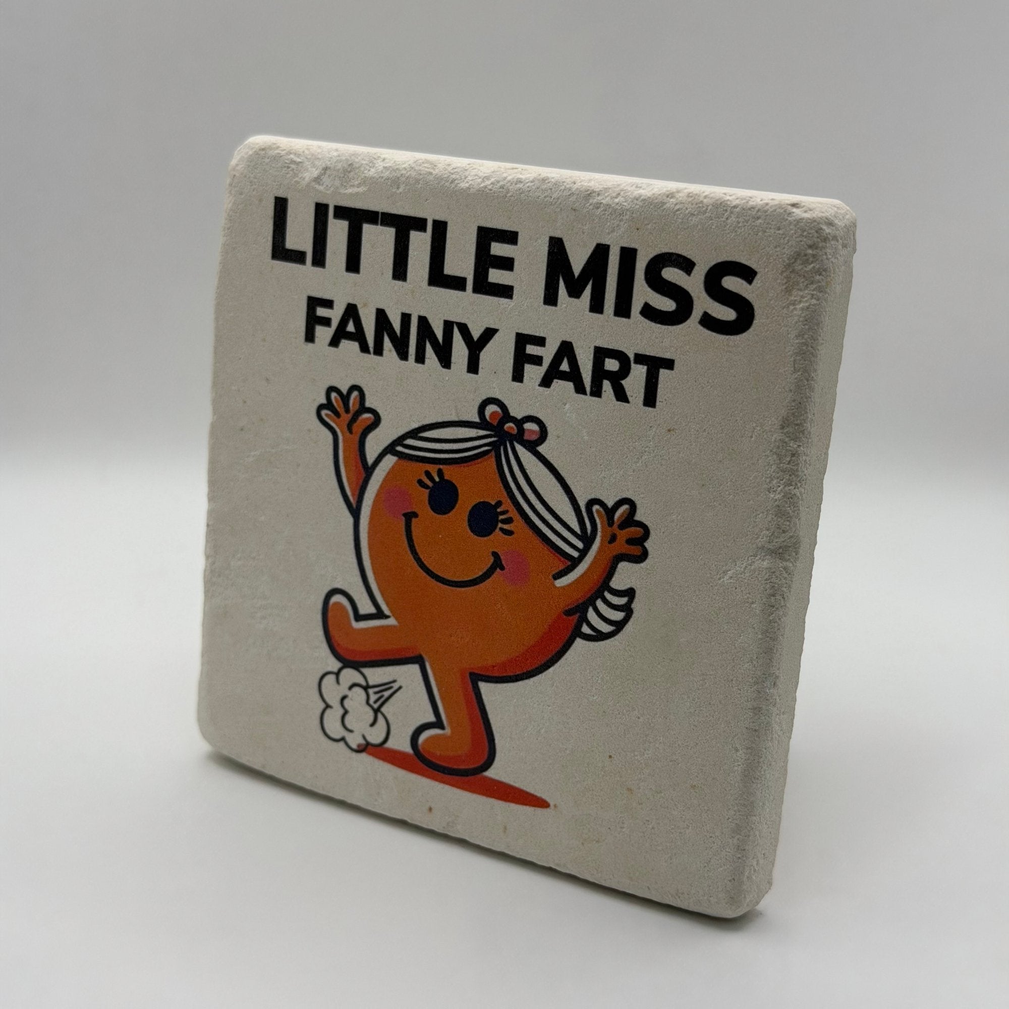 Little Miss Fanny Fart artwork printed on square travertine stone coaster