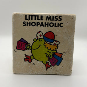 Little Miss Shopaholic illustration printed on square travertine stone coaster
