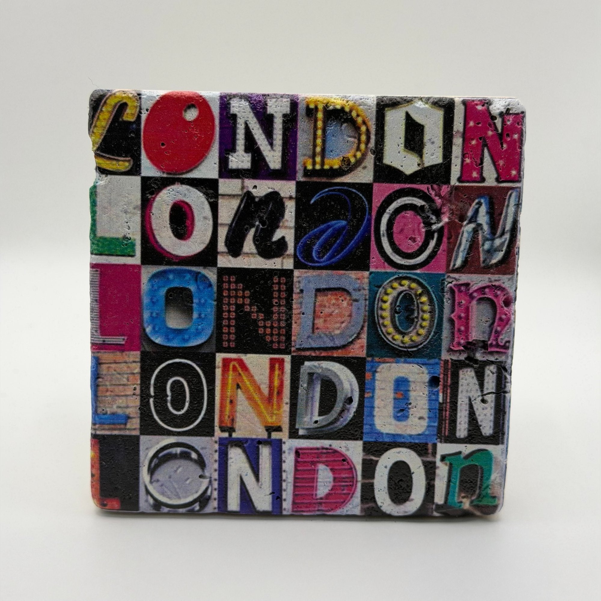 Vintage London alphabet design printed on square travertine stone coaster