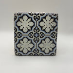 Moroccan-inspired geometric pattern printed on square travertine stone coaster