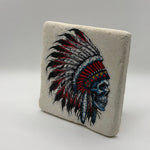 Native American artwork featuring a skull design printed on square travertine stone coaster