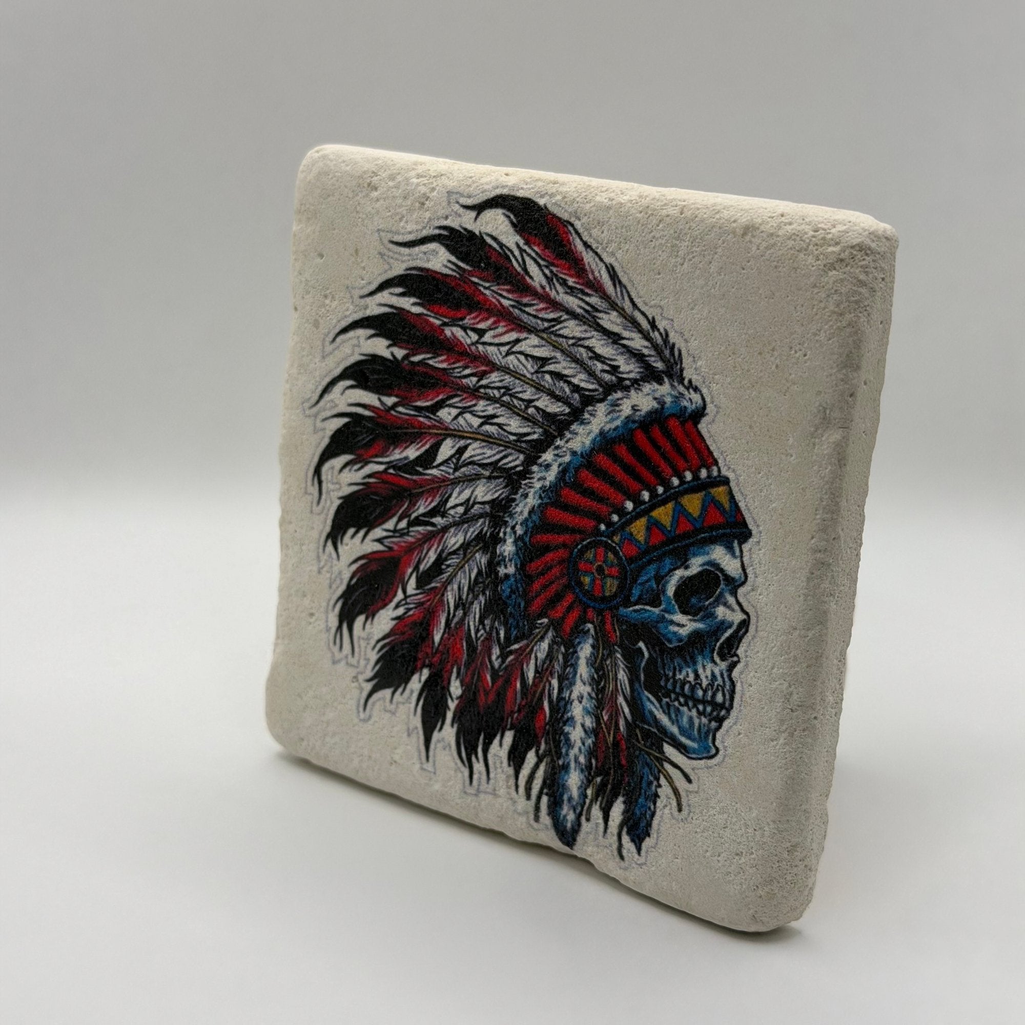 Native American artwork featuring a skull design printed on square travertine stone coaster