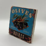 Olives Noires artwork printed on square travertine stone coaster