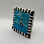 Sailboat artwork printed on square travertine stone coaster