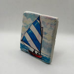 Coastal small boat artwork printed on square natural travertine stone coaster