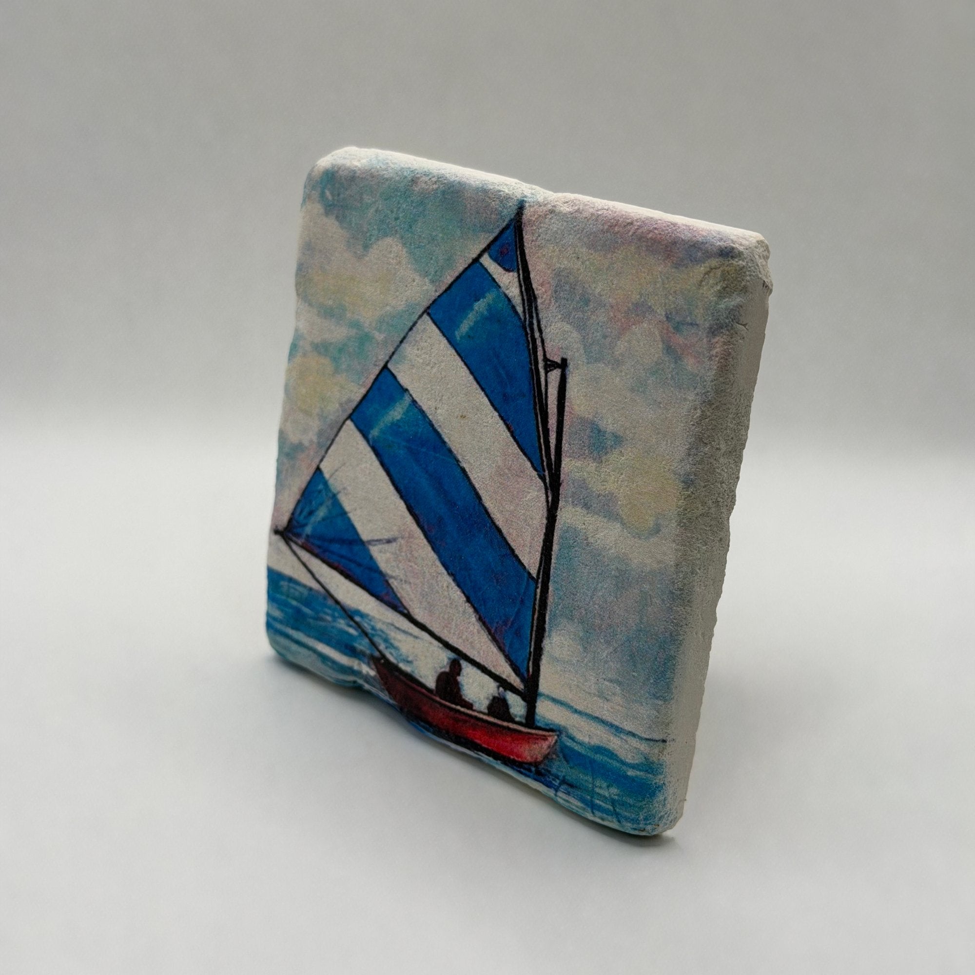 Coastal small boat artwork printed on square natural travertine stone coaster