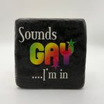 Humorous quote 'Sounds Gay Im In' printed on square travertine stone coaster