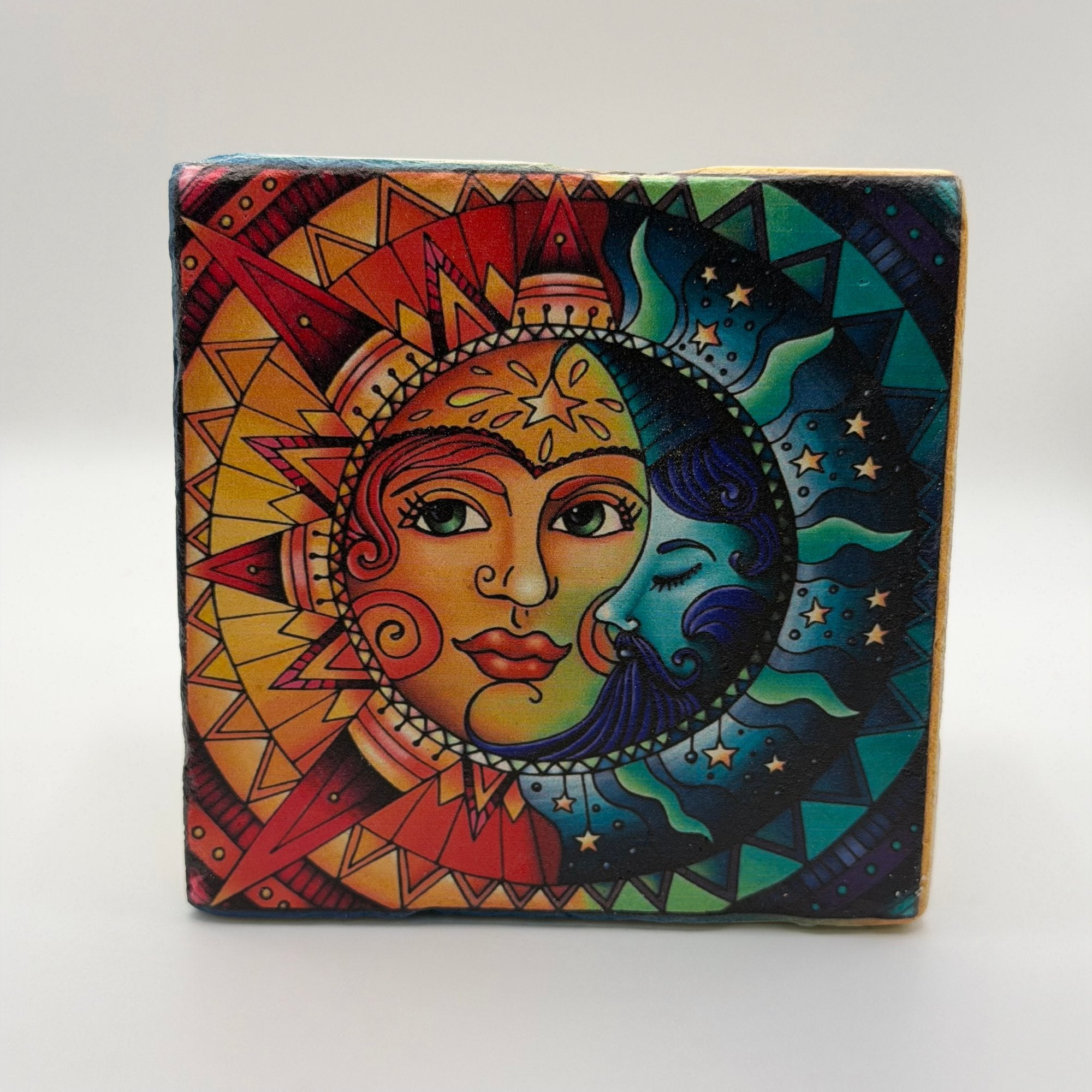 Cosmic design featuring sun and moon printed on square travertine stone coaster