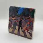 Tintin artwork featuring the Beatles' Abbey Road print on square travertine stone coaster