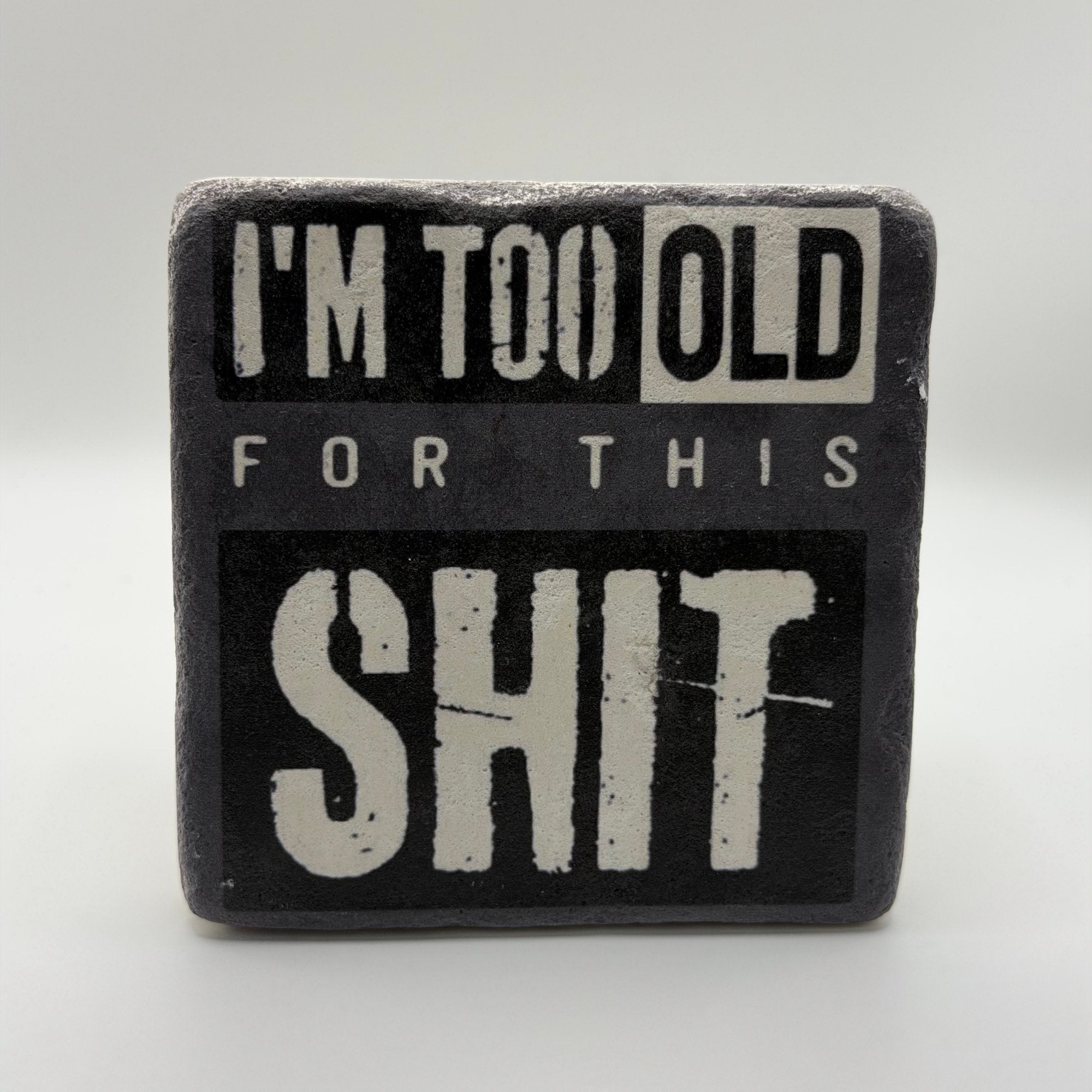 Im Too Old For This Shit slogan printed on square natural travertine stone coaster