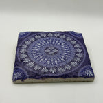 Geometric patterns inspired by tribal cultures printed on square travertine stone coaster