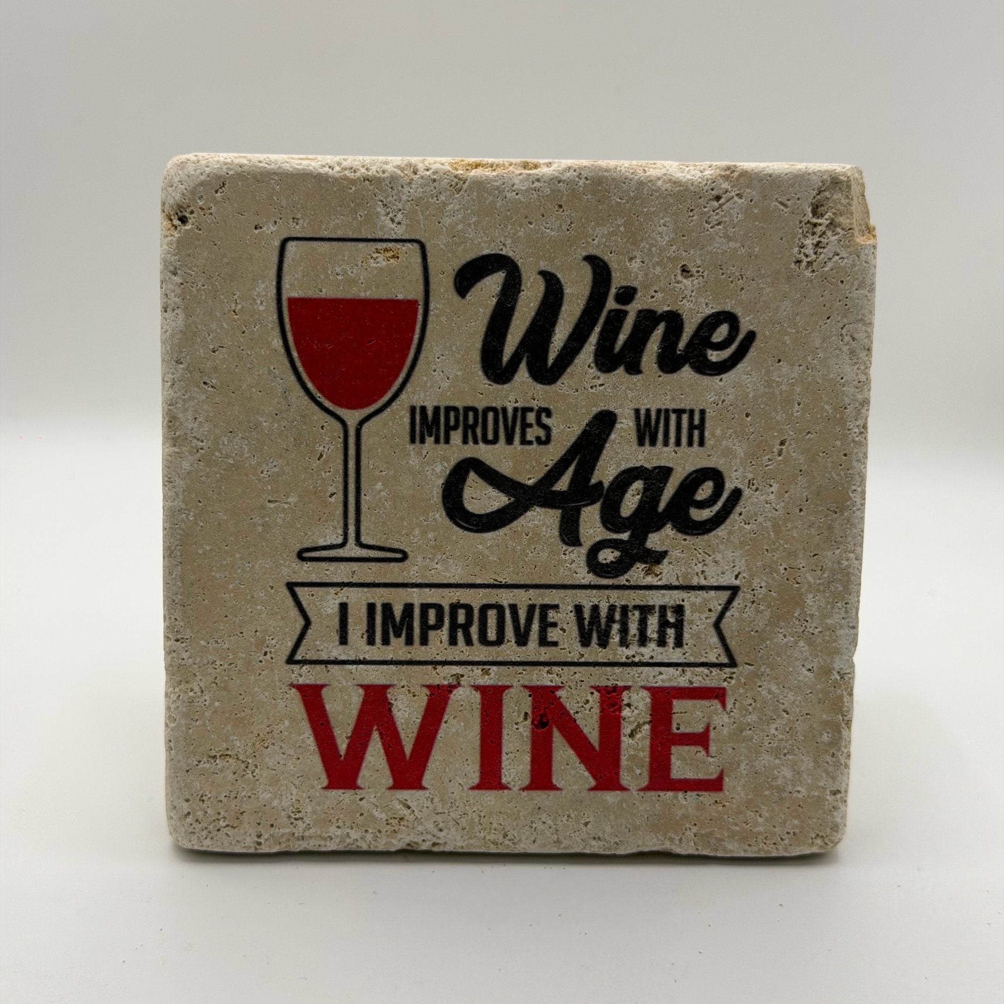Wine improves with age quote printed on square natural travertine stone coaster