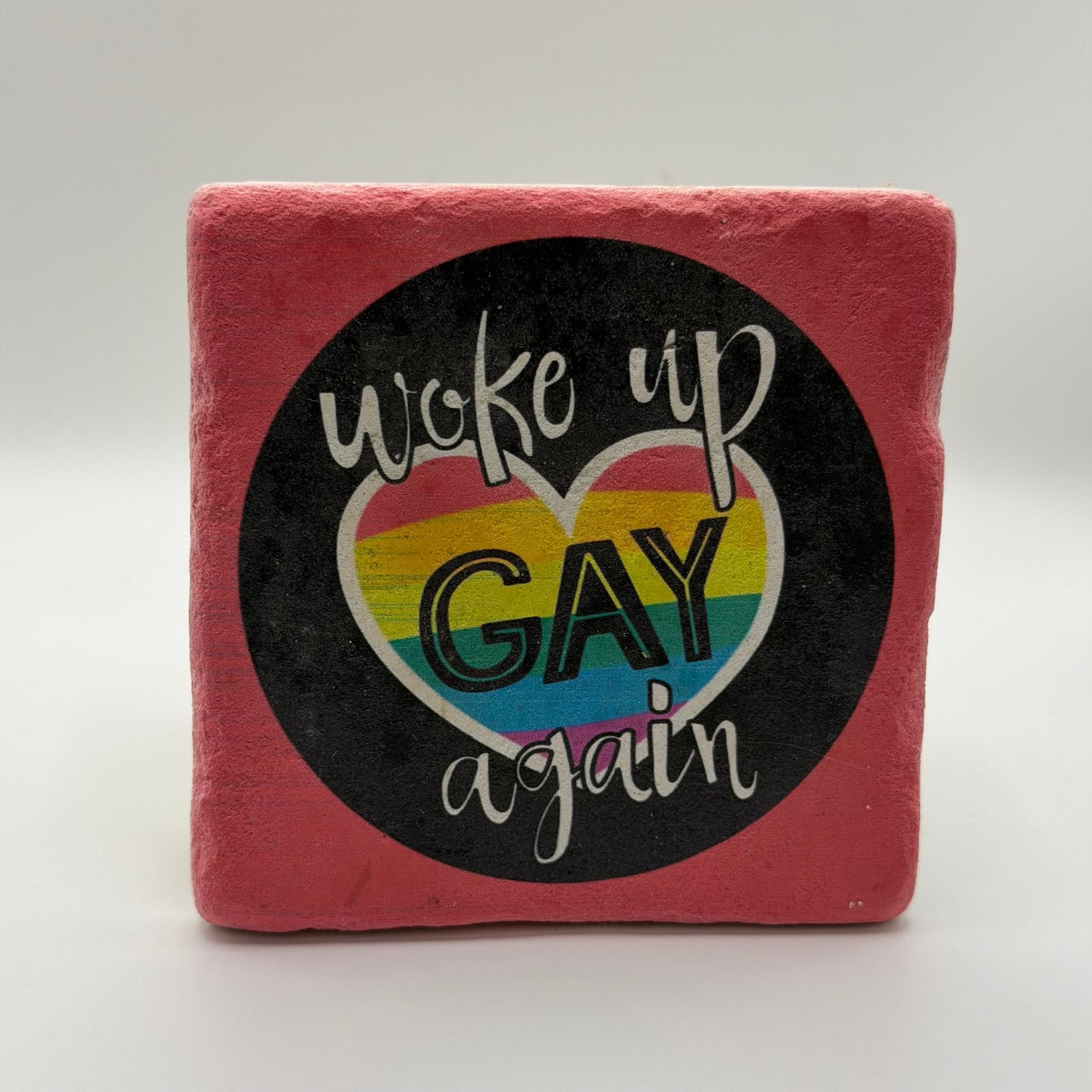 Funny slogan 'Woke Up Gay Again' printed on square travertine stone coaster